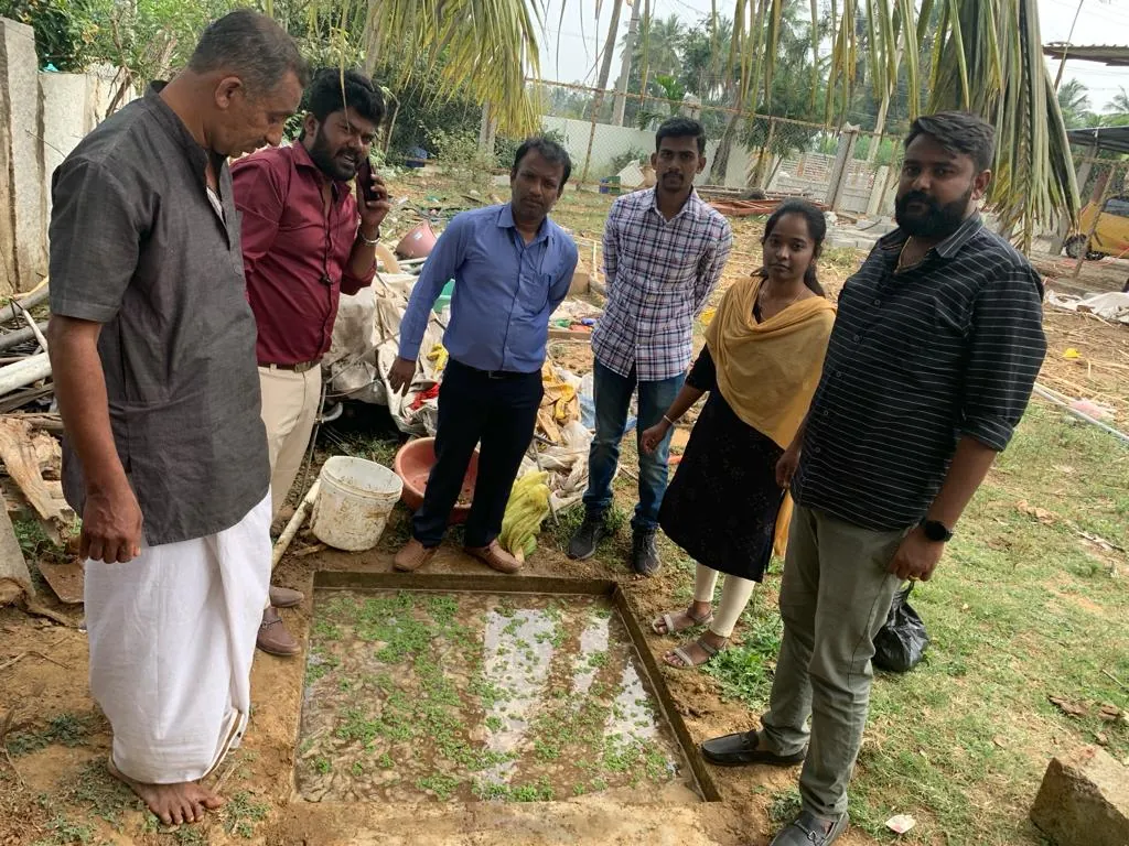 Trust members inspecting a water tank at the goshala site