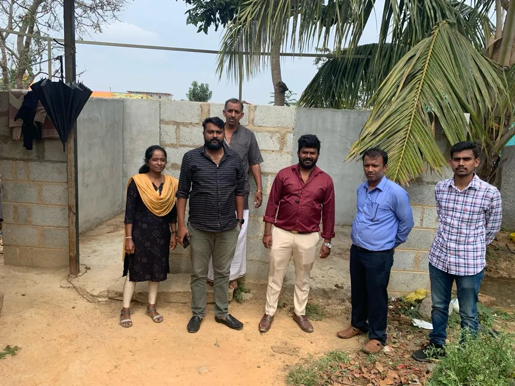 Trust members and volunteers standing at the goshala premises